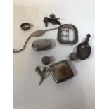 A collection of silver items to include a buckle, snuff box, an identity bracelet and other items
