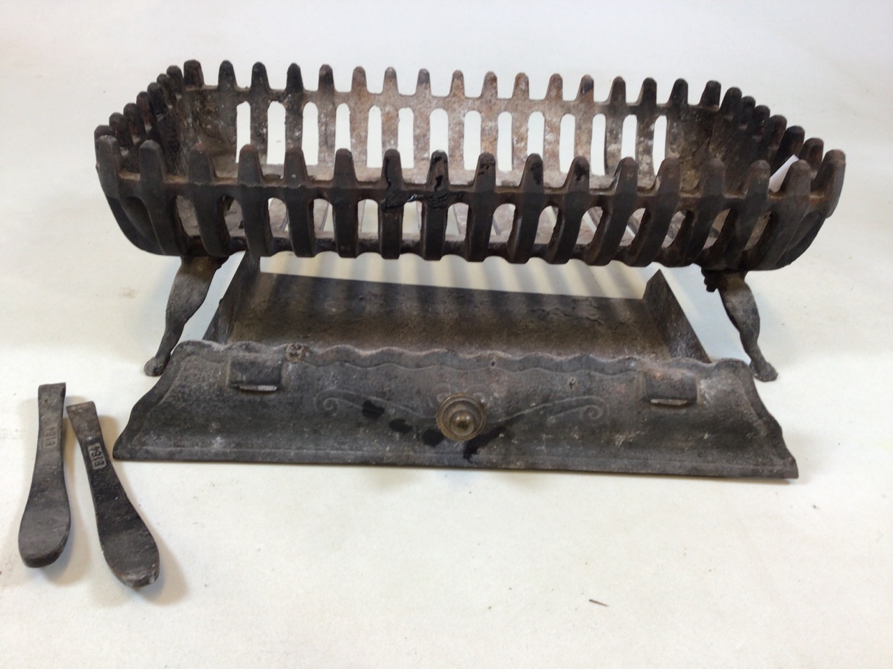 A cast iron fire grate with ash pan W:54cm x D:29cm x H:19cm