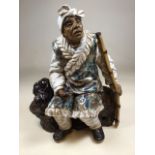 A large pottery figure of an Asian man with pipe. With high firing glazing, with two character marks