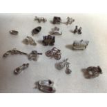 A collection of 17 novelty silver coloured charms - mostly unmarked