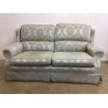 A Damask covered two seater sofa. W:190cm x D:100cm x H:100cm