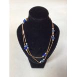 A 9carat gold necklace with blue stones and seed pearls. Length 57cm