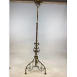 A large brass oil lamp on standard tripod base. H:174cm