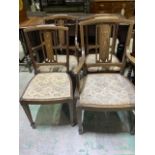 Four Edwardian mahogany inlaid chairs with rosewood and satinwood panels.