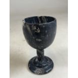 A fossilised chalice. H:16cm
