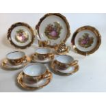 A mid century Schlottenhof gold tea set with Fragonard design. Includes four cups and saucers, tea