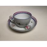 A late 18th early 19th century hand painted tea bowl and saucer.