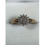 A 9ct gold and diamond clutser ring.
