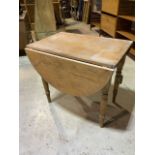 A pine drop flap kitchen table.W:126cm x D:84cm x H:74cm