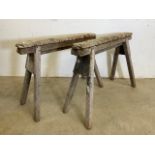 A pair of wooden trestle bases or saw horses.