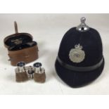 A Police helmet with Devon Constabulary badge together with a chevalier, Paris leather Binocular