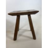 An early elm milking stool with rectangular top and four chamfered legs. W:26cm x D:19cm x H:28cm