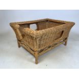 A wicker dog bed. With large handles or windows. W:60cm x D:80cm x H:42cm