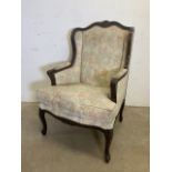 An early 20th century Queen Anne style upholstered wing back arm chair with stud work finish. W: