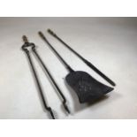 A set of three fire irons including a poker, a shovel and tongs Approx 77cm. Brass and steel,