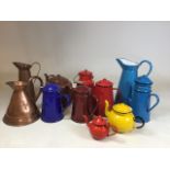 A collection of enamelware to include a large blue jug 32cm high, together with tea pots, coffee