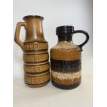 Two West German fat lava handled jugs. H:46cm and H:39cm