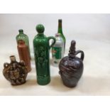 A vintage Gouda Green glazed ceramic liquor bottle, together with a stoneware Calvados flask, an