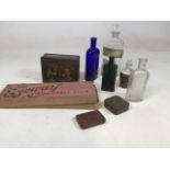 A collection of advertising tins and chemist bottles