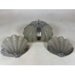 A chrome and glass Art Deco ceiling light and two wall lights. Glass moulded as scalloped shells.