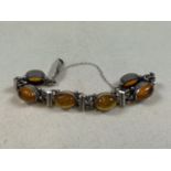 An amber and silver bracelet.