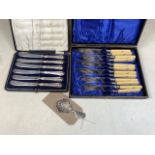 A Cased set of silver handled knives also with silver collared fish knives and forks and silver