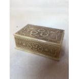 A hand carved bone trinket box decorated with flowers, lined with velvetW:10.5cm x D:7cm x H:4cm