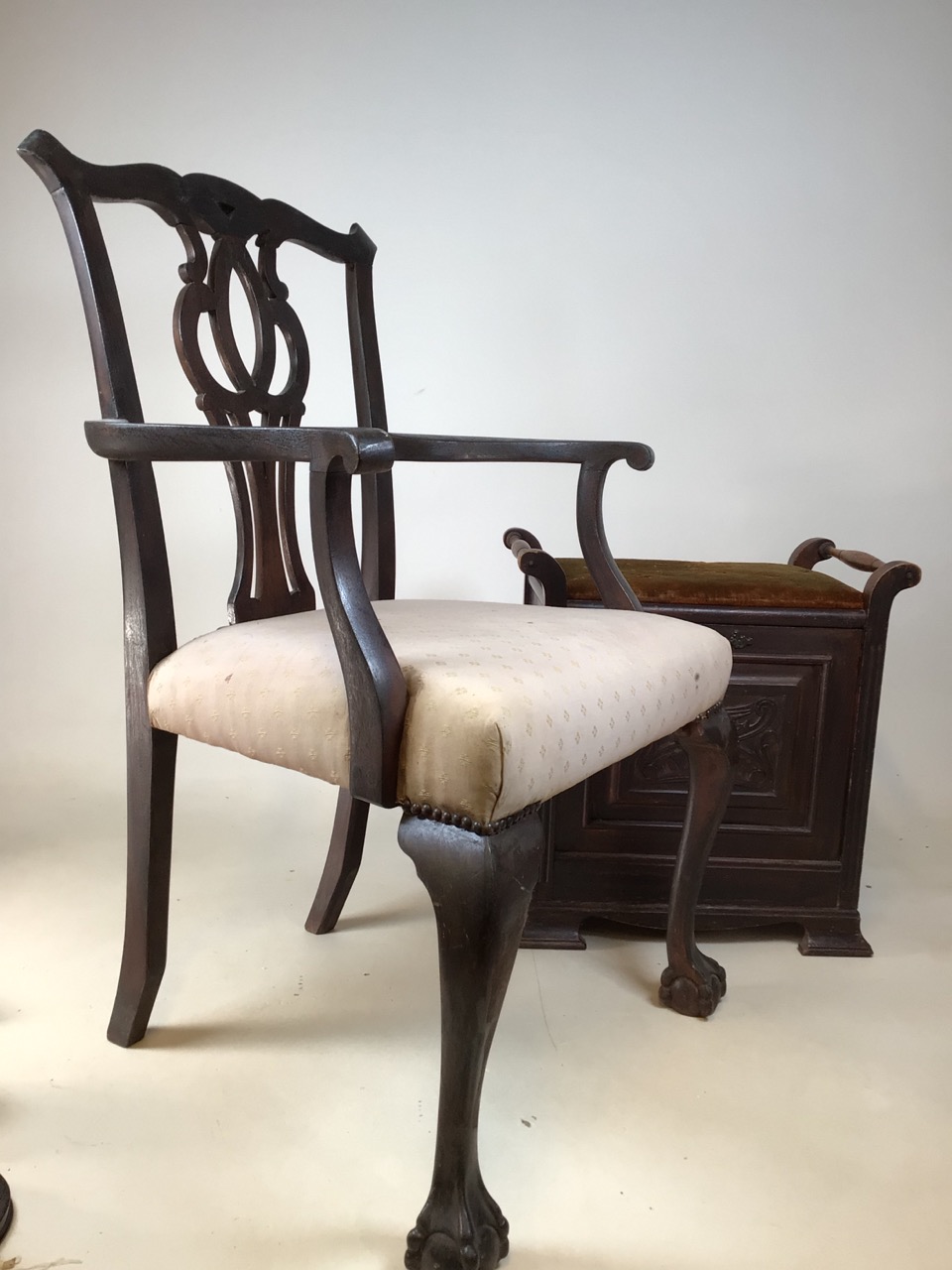 A twentieth century ball and claw foot chair together with a twentieth century upholstered piano