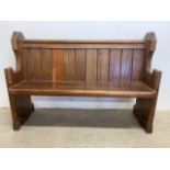 A small pitch pine pew.W:126cm x D:47cm x H:86cm