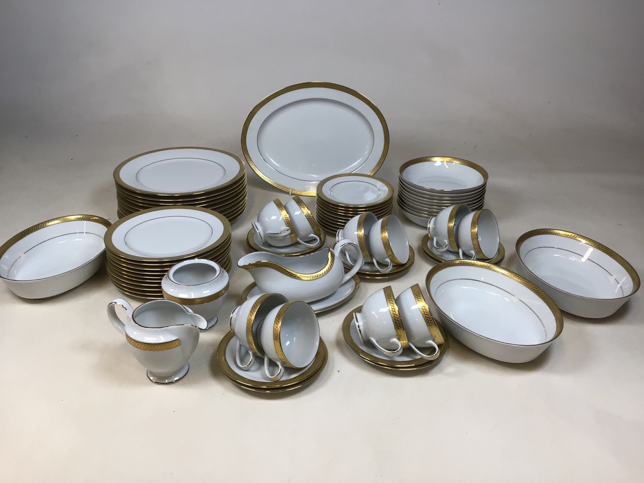 A Fairmont Fine China Linton Gold 9303 dinner service for ten. Includes dinner plates, breakfast