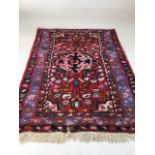 A small vintage rug - some moth damage W:62cm x H:94cm includes fringe
