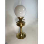 A early 20th century brass oil lamp with glass chimney and opaque white shade. H:59cm