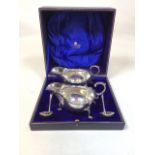 A boxed pair of silver sauce boats with ladles. Retailed by Rainforth & Sons. Hallmarked Sheffield