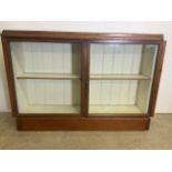 An early 20th century glazed double cupboard with painted interior and shelf. W:135cm x D:32cm x