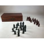 A wooden cased oriental style chess set. Resin figures