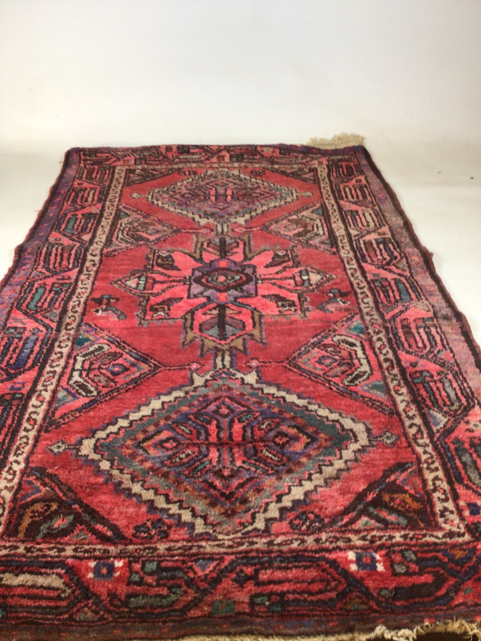 A vintage handmade Iranian rugW:95cm x H:156cm includes fringe