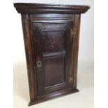 A late eighteenth, early nineteen century oak corner cupboard. Two shelves within. Original back