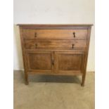 An early 20th century oak cupboard with two drawers above with metal handles. W:95cm x D:47cm x