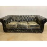 A black leather three seater chesterfield style sofa.W:190cm x D:90cm x H:66cm