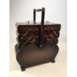 A 1930s Cantilever sewing box with contents W:50cm x D:24cm x H:61cm dimensions include handle