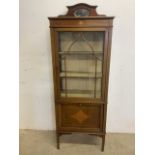 An inlaid Edwardian glazed cabinet with sectioned stationery cupboard beneath with mirrored cornice.