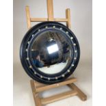 An early 20th century black painted circular convex mirror. Decorated with glass buttons. W:42cm x