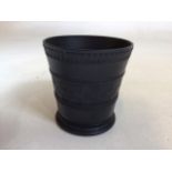 A Wedgwood black basalt vase with engine turned decoration signed 1933 Andrew Dykes. Height 10cm