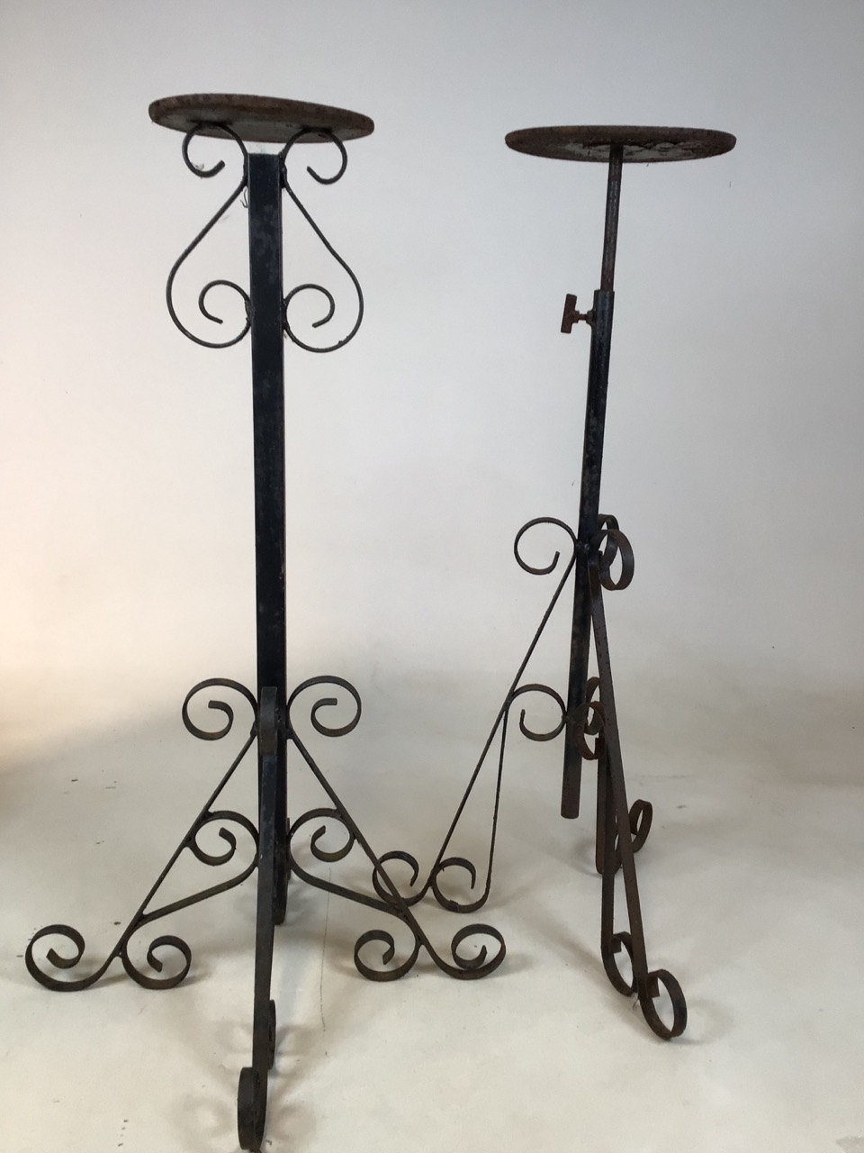 Two metal garden stands - one is adjustable