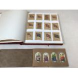 A well presented album containing silk cigarette card including flags and flowers together with a