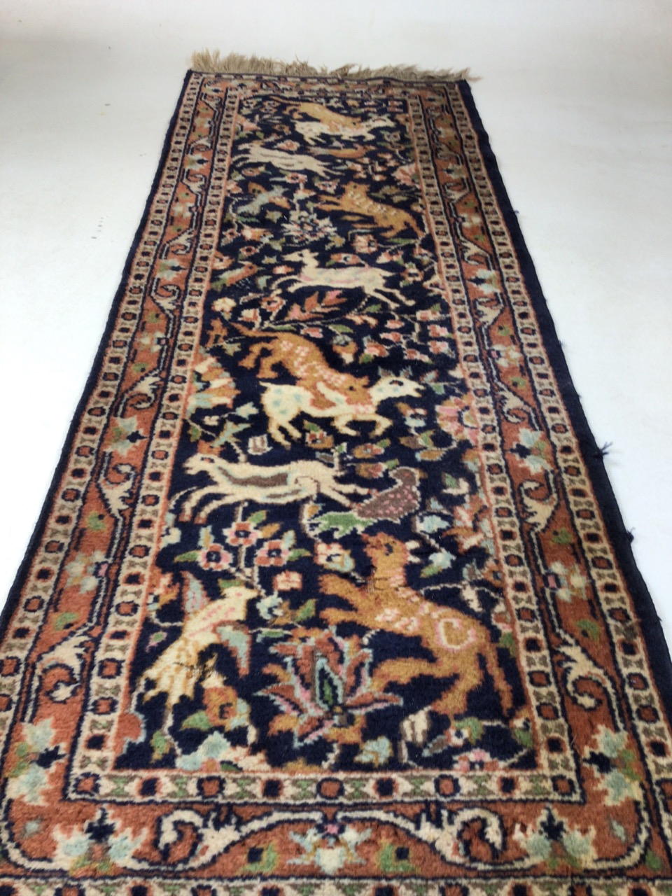 A vintage Persian wool rug with navy ground and hunting animalsW:46cm x H:137cm includes fringe - Image 4 of 4