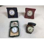 Four travel and pocket watches in case. Untested