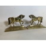 A pair of brass horse fire dogs. W:24cm x D:6.5cm x H:16cm