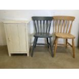 A small early 20th century painted pine cupboard also with two beech kitchen chairs, one painted.