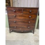 A Victorian mahogany veneered bow fronted chest of drawers, two short over three long drawers with